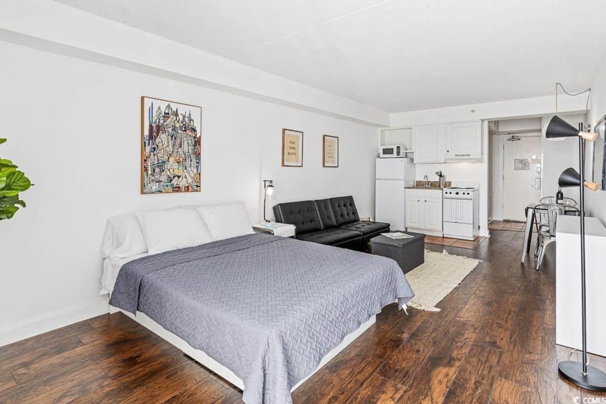 1207 South Ocean Boulevard, Unit 21001 Myrtle Beach, SC 29577 - Photo 8 of 23 Bedroom with dark wood-style floors and freestanding refrigerator