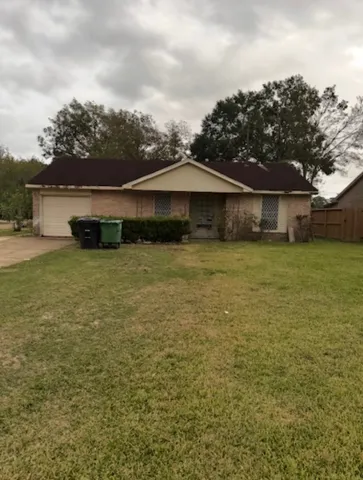 a view of a house with yard and trampoline
