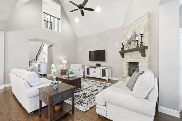 a living room with fireplace furniture and a flat screen tv