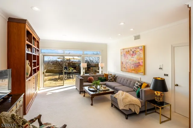 a living room with furniture and a floor to ceiling window