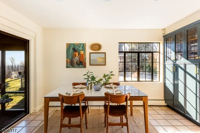 a view of a dining room with furniture and a window