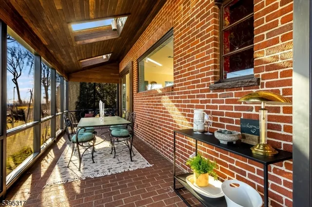 a view of a patio with a table and chairs and potted plants