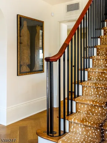 a view of staircase with railing and a potted plant