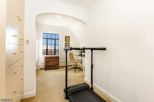 a living room with furniture a flat screen tv and a large window