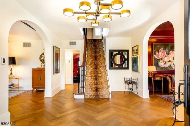 a view of a livingroom with furniture cabinet and a chandelier