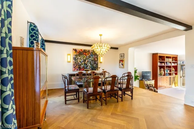 a view of a dining room with furniture and chandelier