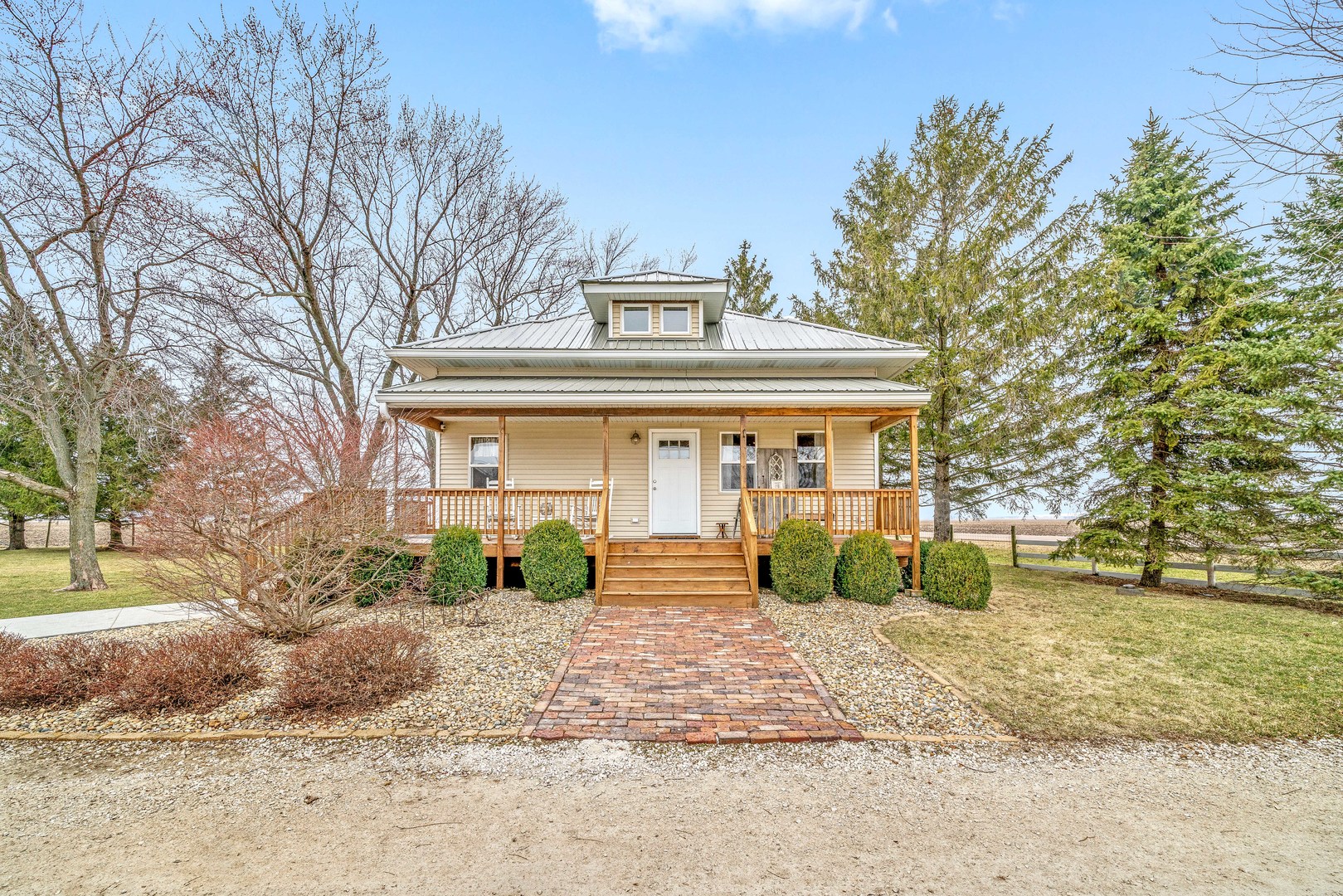 11036 Chicago Road Waterman, IL 60556 - Photo 1 of 43 a front view of a house with garden