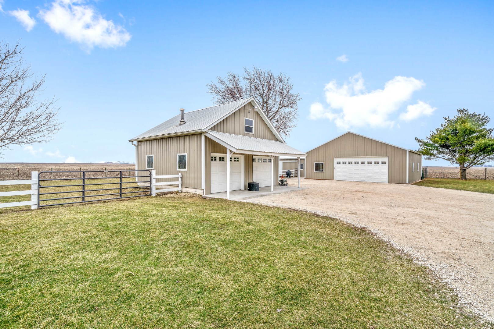 11036 Chicago Road Waterman, IL 60556 - Photo 40 of 43 a front view of a house with a yard and garage