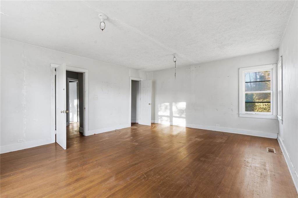 1805 Blue Ridge Drive Blue Ridge, GA 30513 - Photo 23 of 31 a view of an empty room with wooden floor and a window
