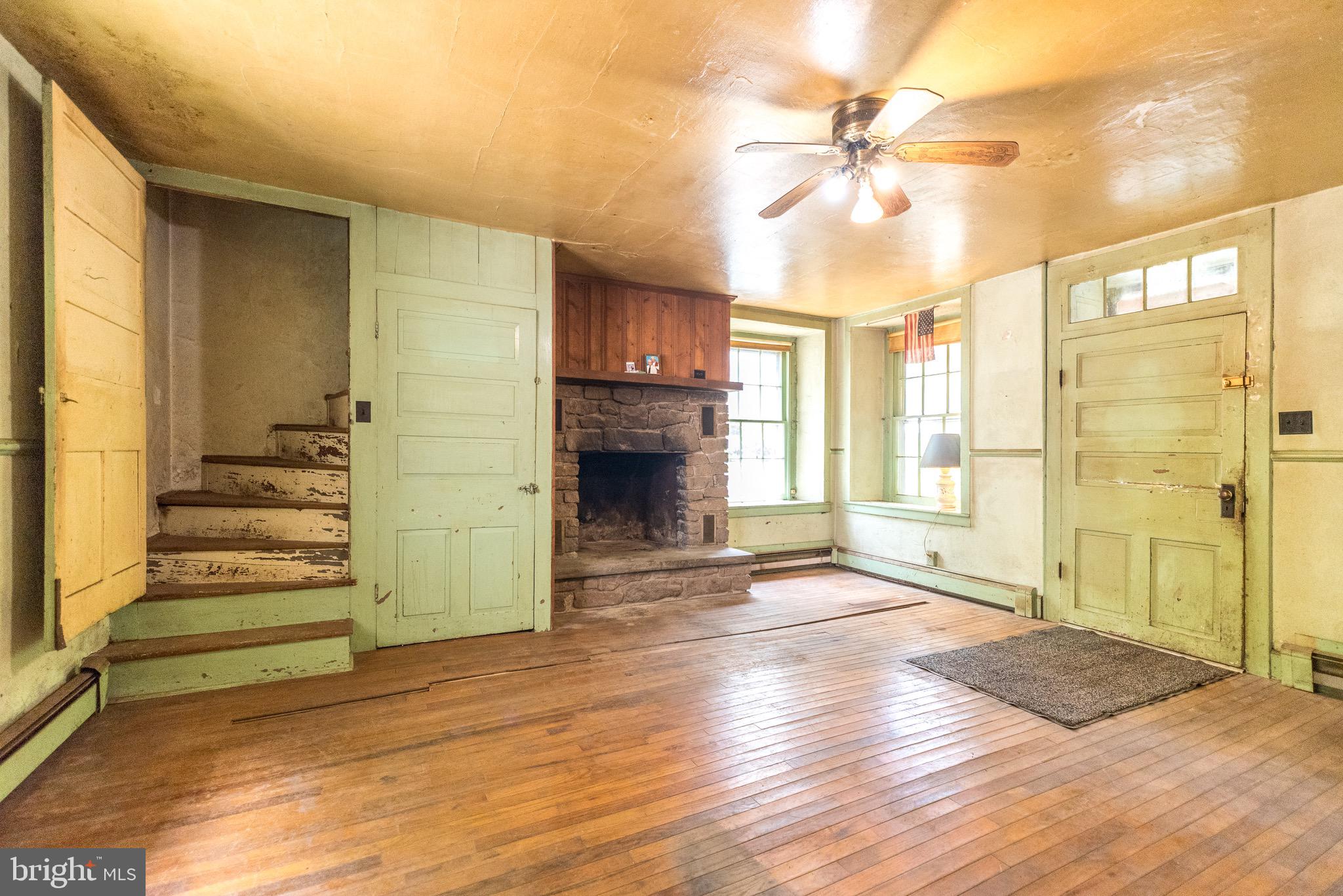 118 Geigel Hill Road Erwinna, PA 18920 - Photo 14 of 30 a view of a livingroom with wooden floor and a ceiling fan