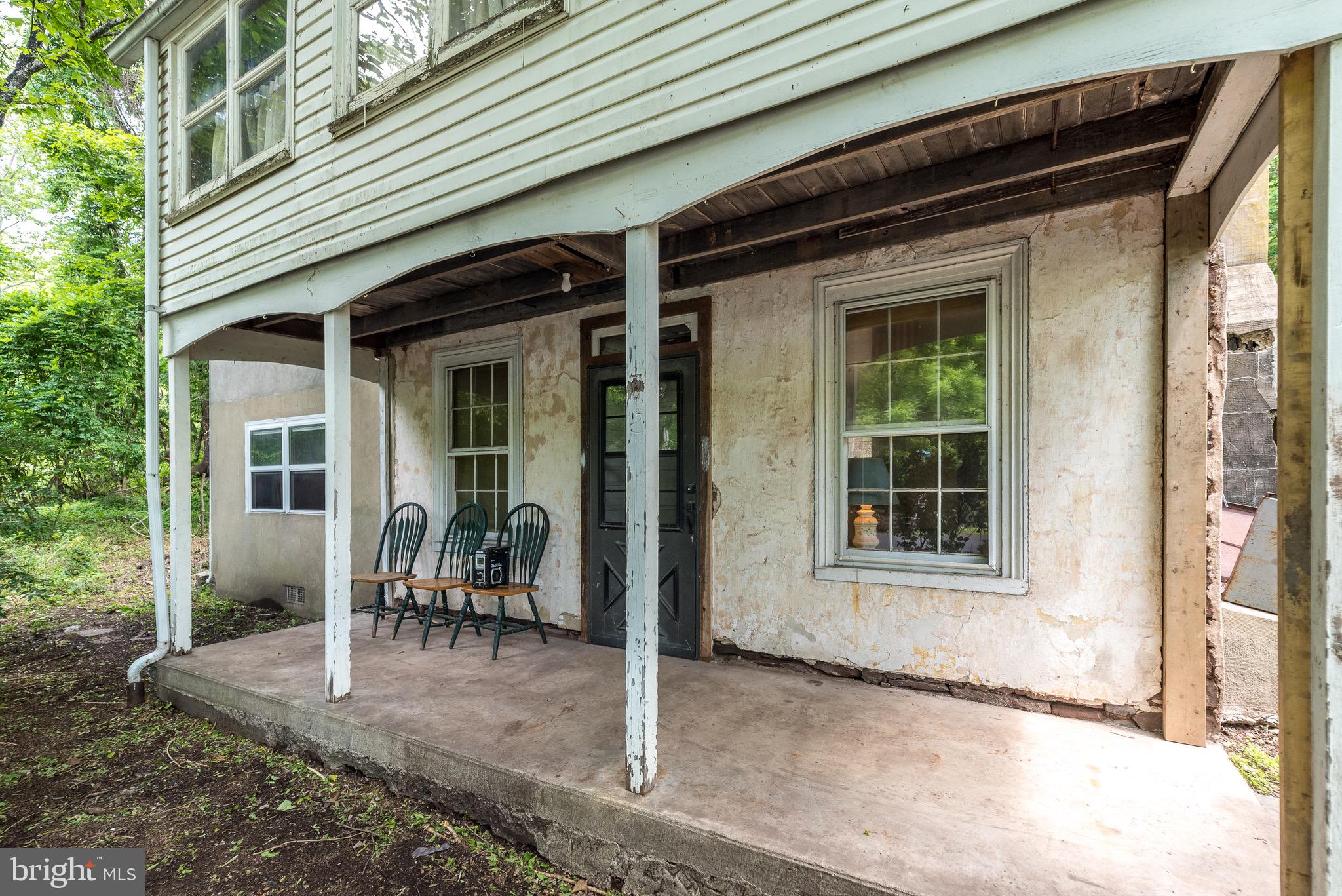 118 Geigel Hill Road Erwinna, PA 18920 - Photo 4 of 30 a view of a house with a wooden bench and floor to ceiling windows
