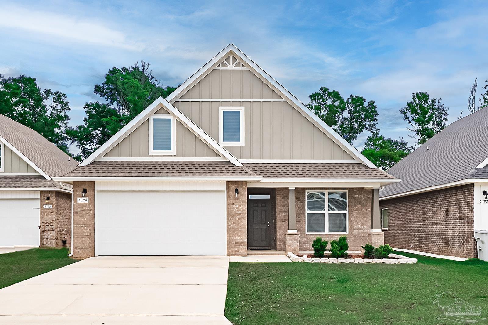 5398 Parkside Drive Pace, FL 32571 - Photo 1 of 36 a front view of a house with a yard and plants