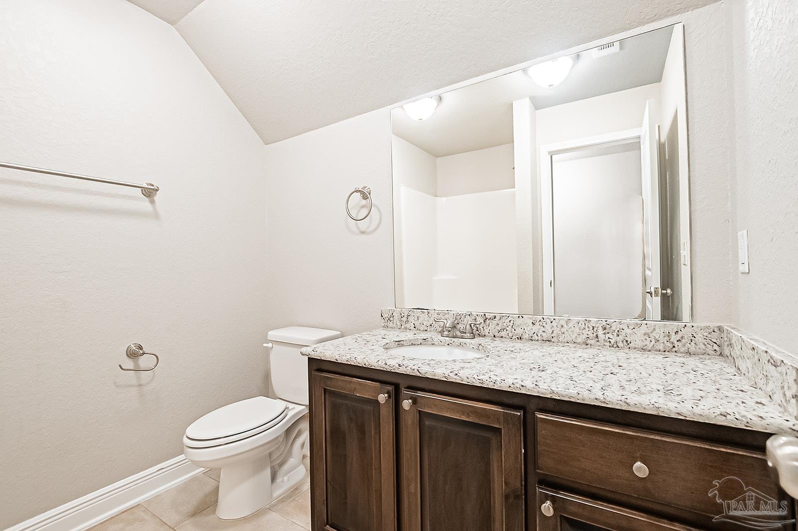 5398 Parkside Drive Pace, FL 32571 - Photo 18 of 36 a bathroom with a granite countertop sink a toilet and a mirror