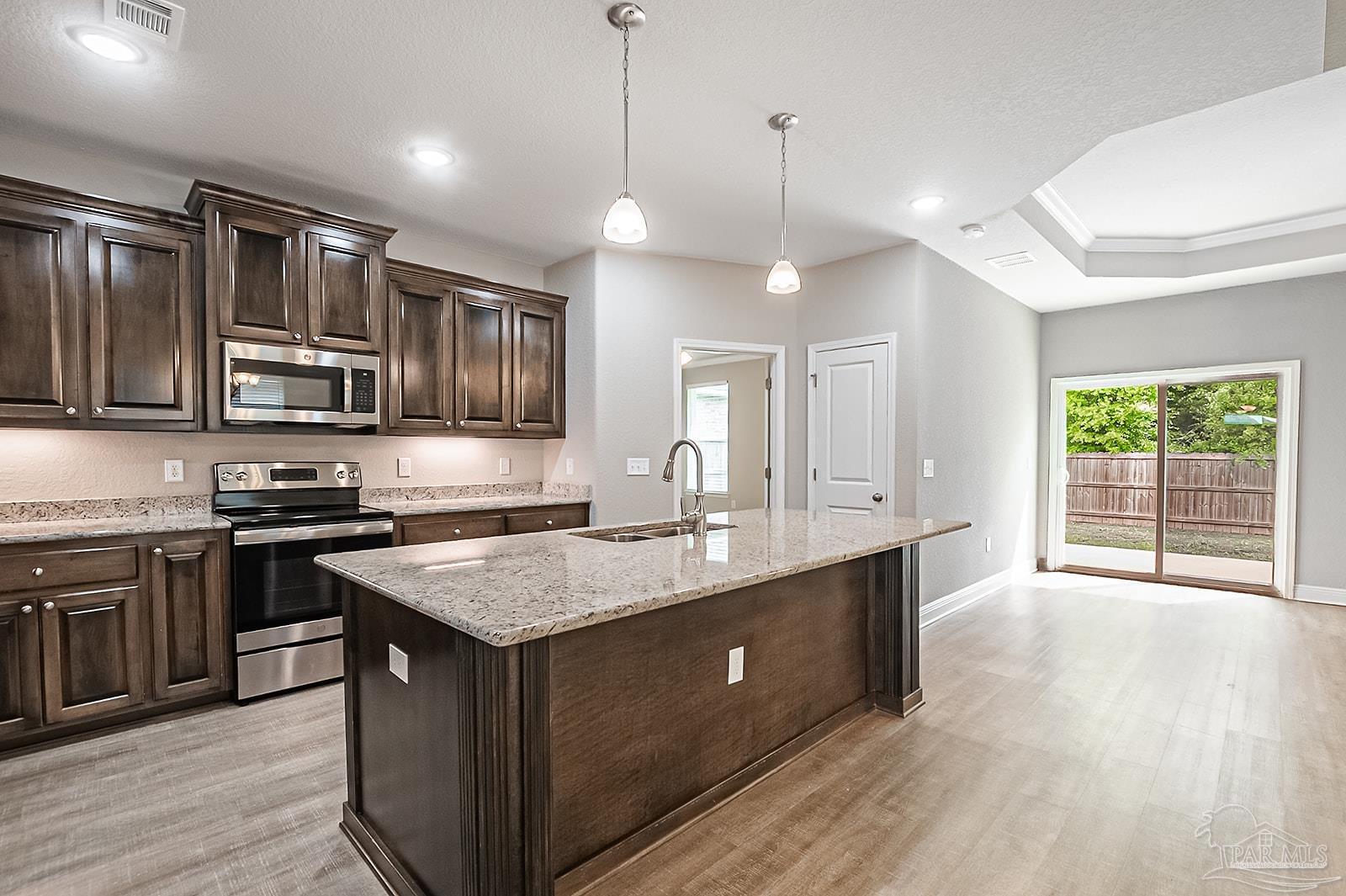 5398 Parkside Drive Pace, FL 32571 - Photo 24 of 36 a kitchen with stainless steel appliances granite countertop a sink stove and refrigerator