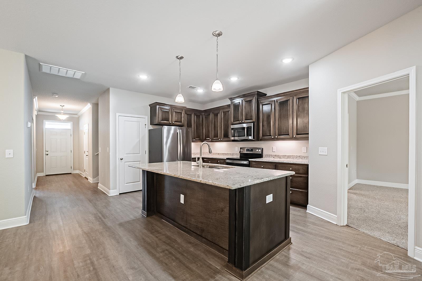 5398 Parkside Drive Pace, FL 32571 - Photo 25 of 36 a kitchen with stainless steel appliances granite countertop a sink a stove and a refrigerator