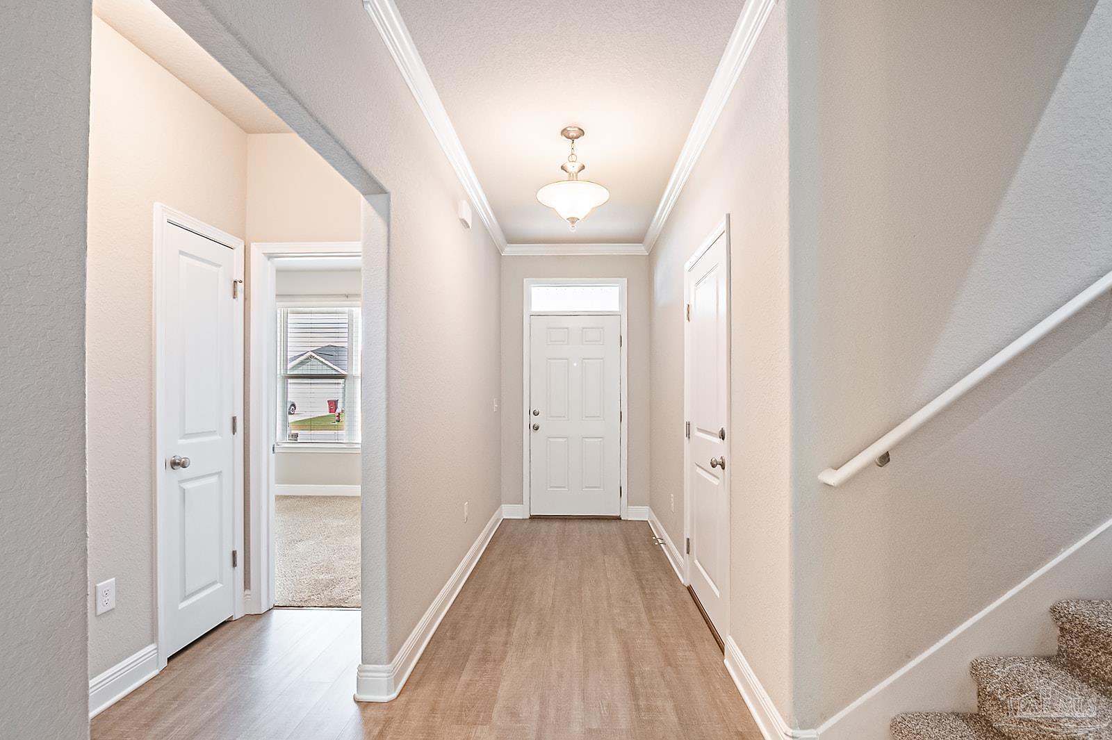 5398 Parkside Drive Pace, FL 32571 - Photo 6 of 36 a view of a hallway with wooden floor and closet