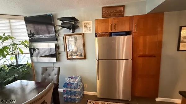 a kitchen with stainless steel appliances granite countertop a refrigerator and a stove