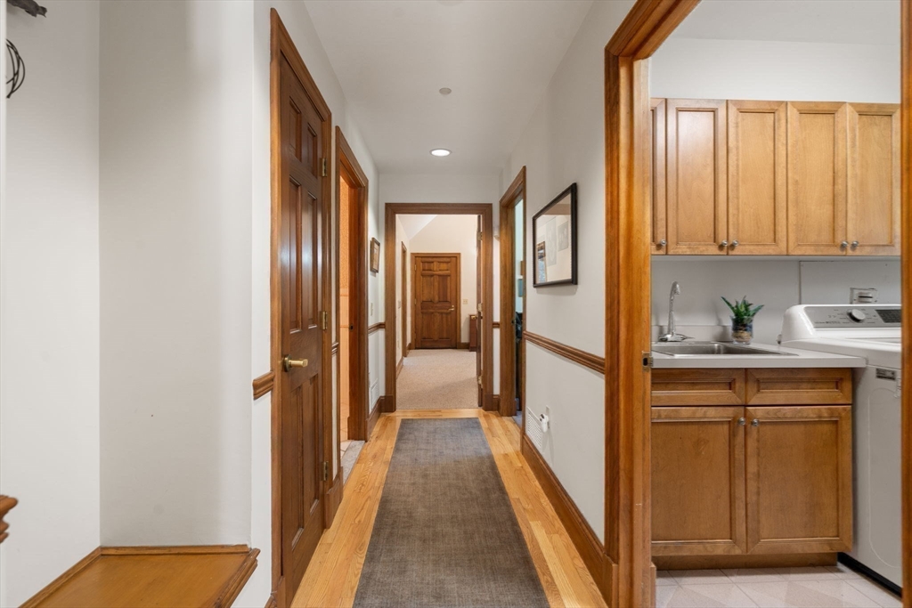 530 Clinton Road Brookline, MA 02467 - Photo 13 of 25 a view of a hallway with wooden floor and staircase