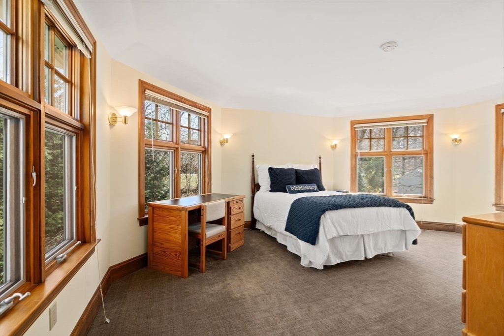 530 Clinton Road Brookline, MA 02467 - Photo 16 of 25 a bedroom with a bed and glass door