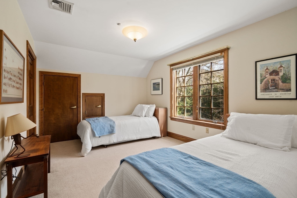 530 Clinton Road Brookline, MA 02467 - Photo 17 of 25 a bedroom with furniture and large window