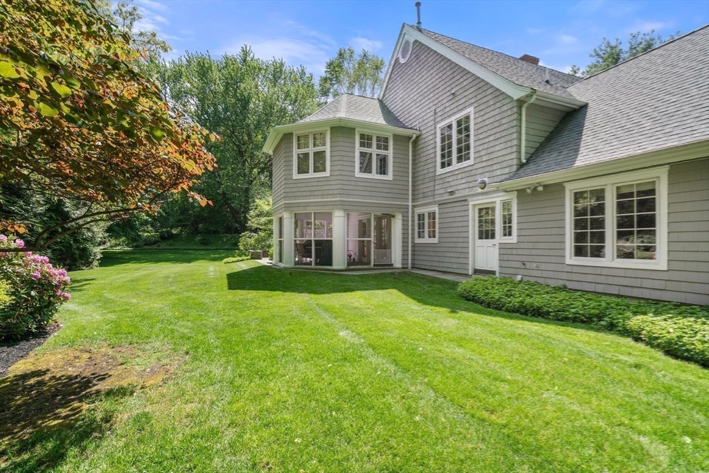 530 Clinton Road Brookline, MA 02467 - Photo 19 of 25 a view of a big house with a big yard and large trees