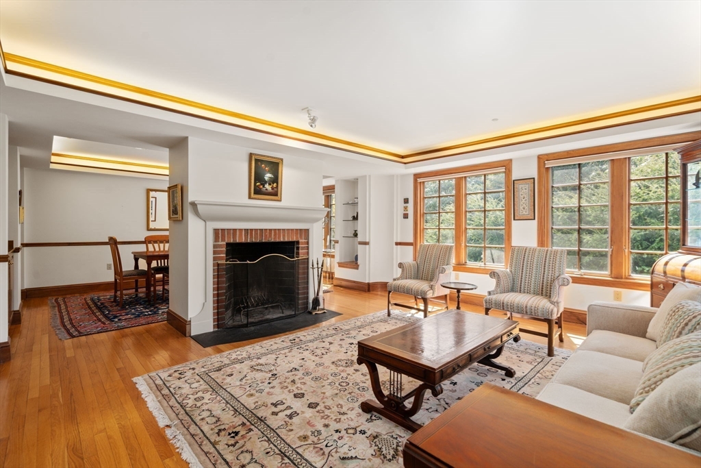 530 Clinton Road Brookline, MA 02467 - Photo 5 of 25 a living room with furniture and a fireplace