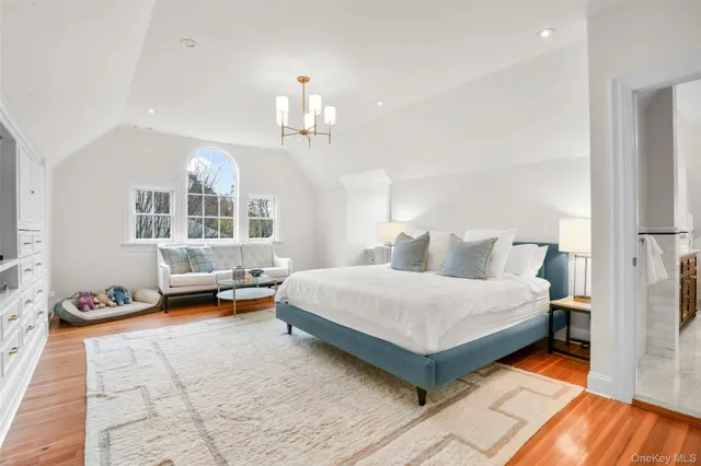 a spacious bathroom with a double vanity sink a large mirror and a bathtub