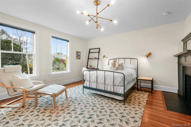 a bedroom with a bed wooden floor and a lamp