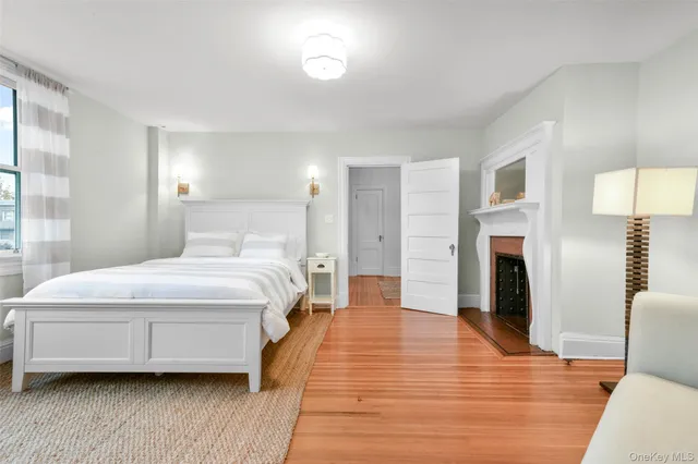a living room with furniture flat screen tv and window
