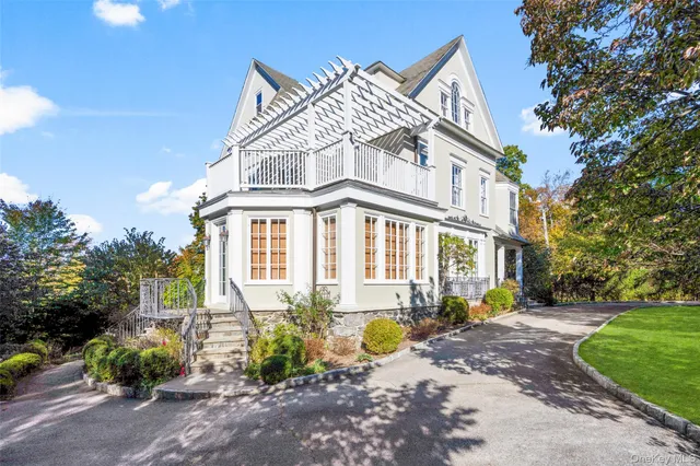 a front view of a house with a garden and plants