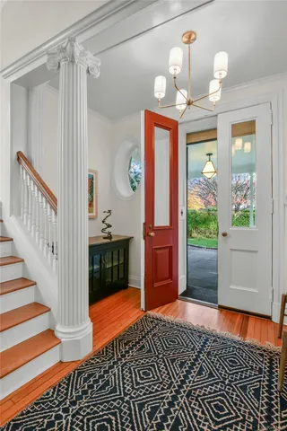 a kitchen view with stainless steel appliances granite countertop a dining table chairs and granite counter tops