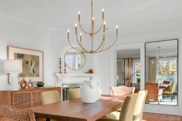 a dining room with furniture a large window and a chandelier