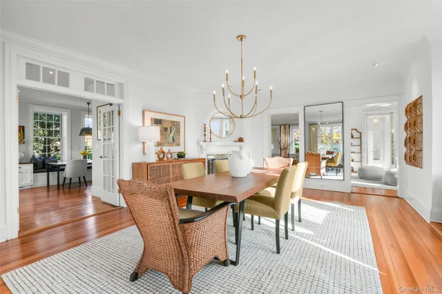 a view of a dining room with furniture wooden floor and chandelier