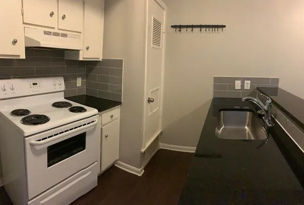 a stove top oven sitting inside of a kitchen