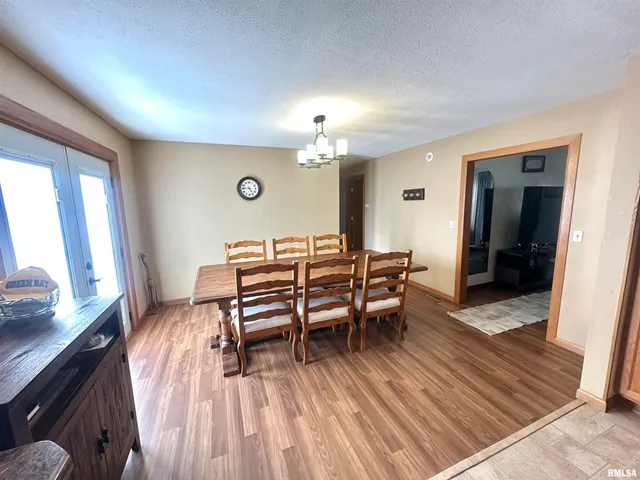 a dining room with furniture and wooden floor