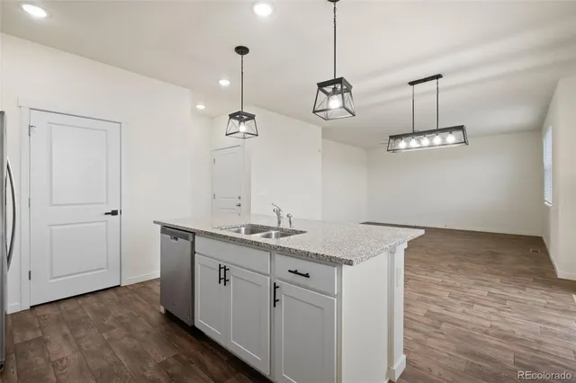a kitchen with a sink and chandelier