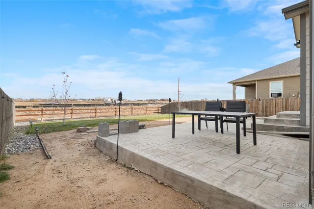a front view of a house with swimming pool and furniture