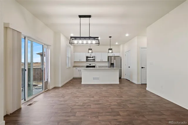 a view of kitchen with refrigerator and window