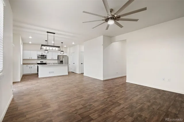 a view of a kitchen with a sink and a refrigerator
