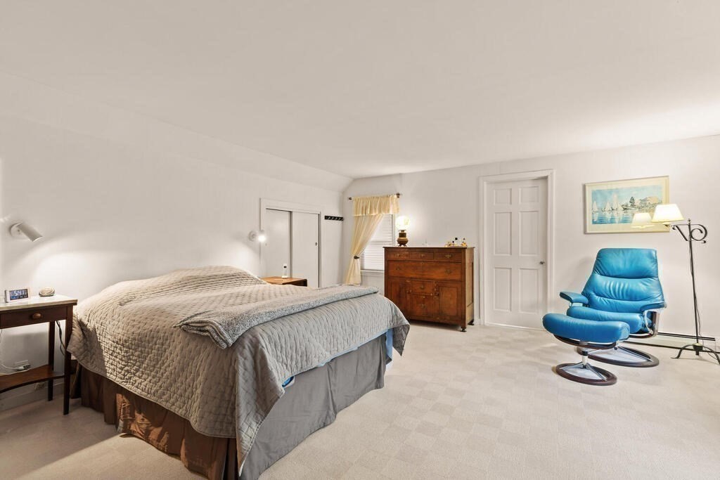 82 Cary Avenue Lexington, MA 02421 - Photo 20 of 29 a spacious bedroom with a bed and a chair