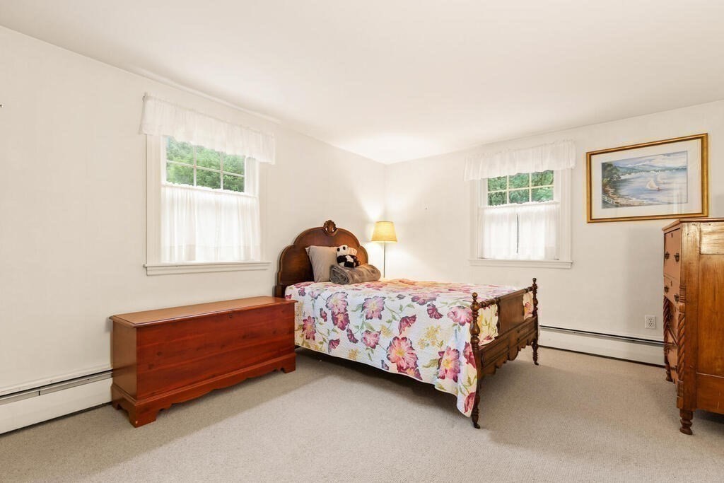 82 Cary Avenue Lexington, MA 02421 - Photo 23 of 29 a bedroom with a bed lamp and a window
