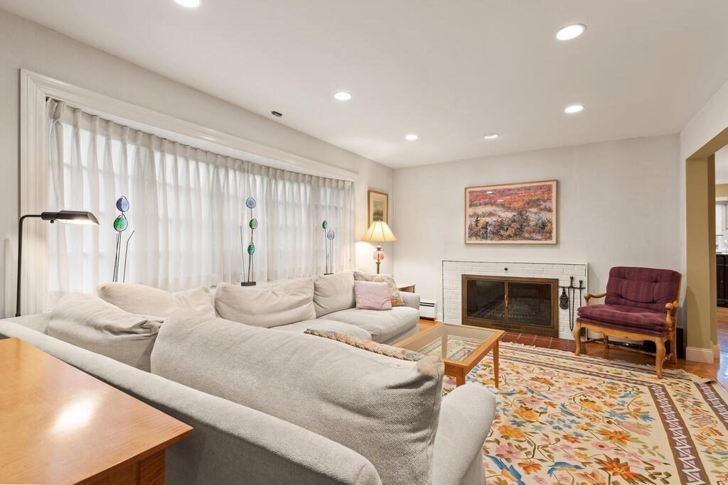 82 Cary Avenue Lexington, MA 02421 - Photo 5 of 29 a living room with furniture and a fireplace