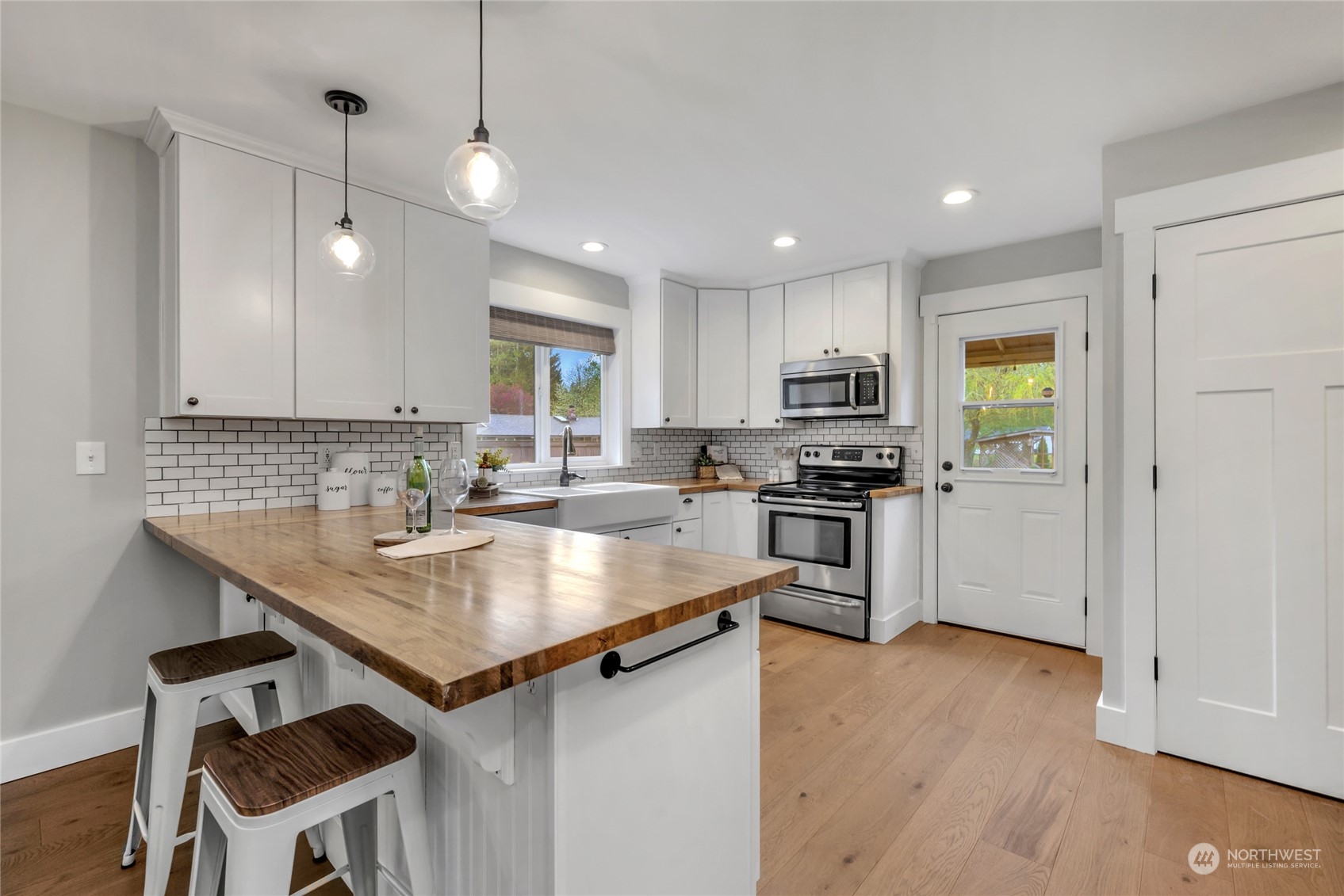 25323 Cromwell Road Monroe, WA 98272 - Photo 11 of 38 a kitchen with a sink stainless steel appliances and white cabinets
