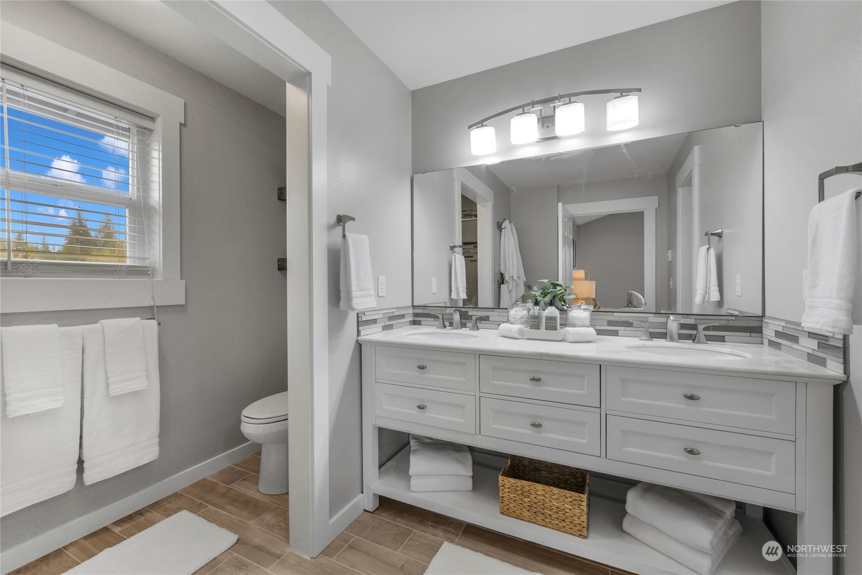 25323 Cromwell Road Monroe, WA 98272 - Photo 22 of 38 a bathroom with a double vanity sink a toilet and a mirror