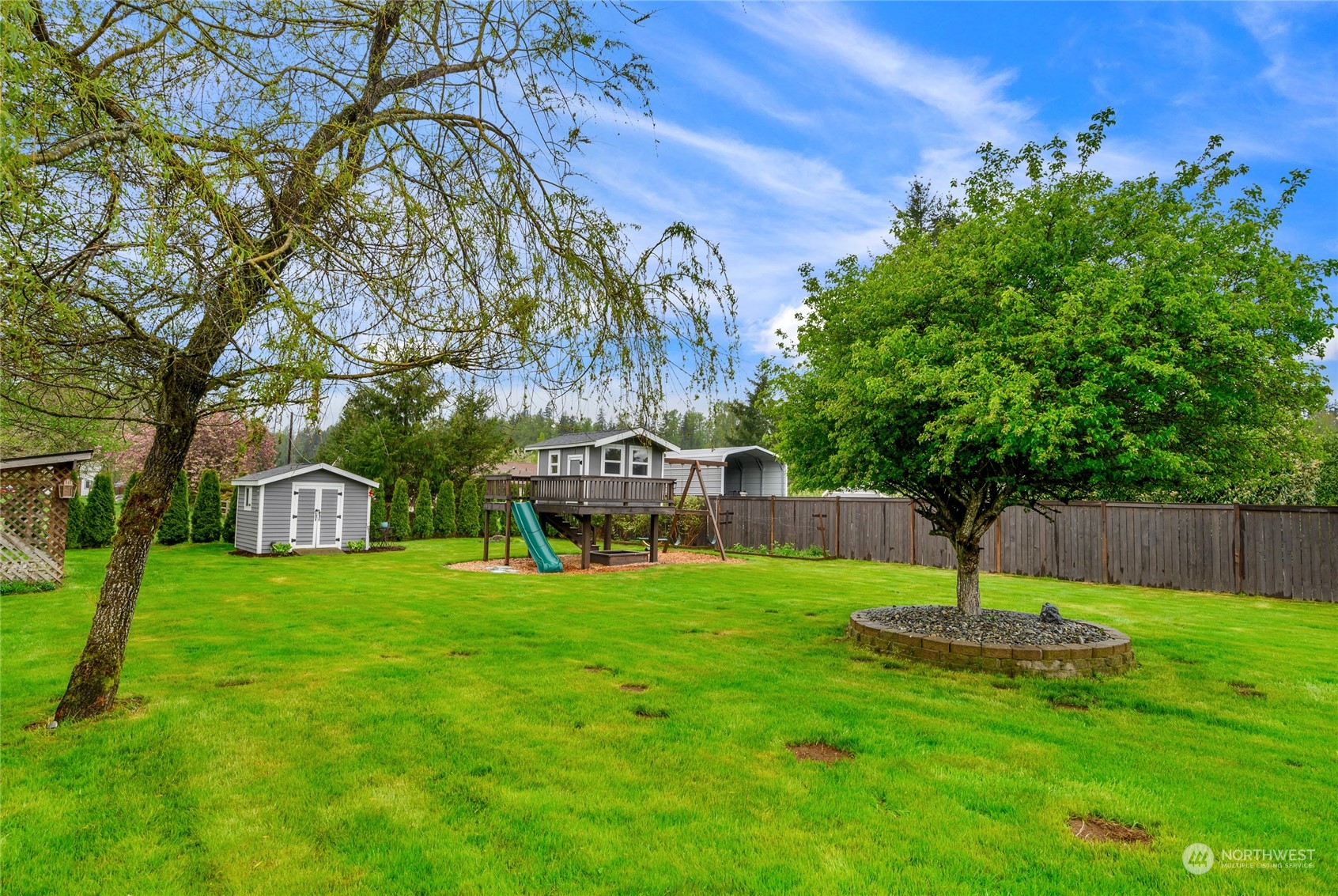 25323 Cromwell Road Monroe, WA 98272 - Photo 26 of 38 a swimming pool with lots of tress in front of it
