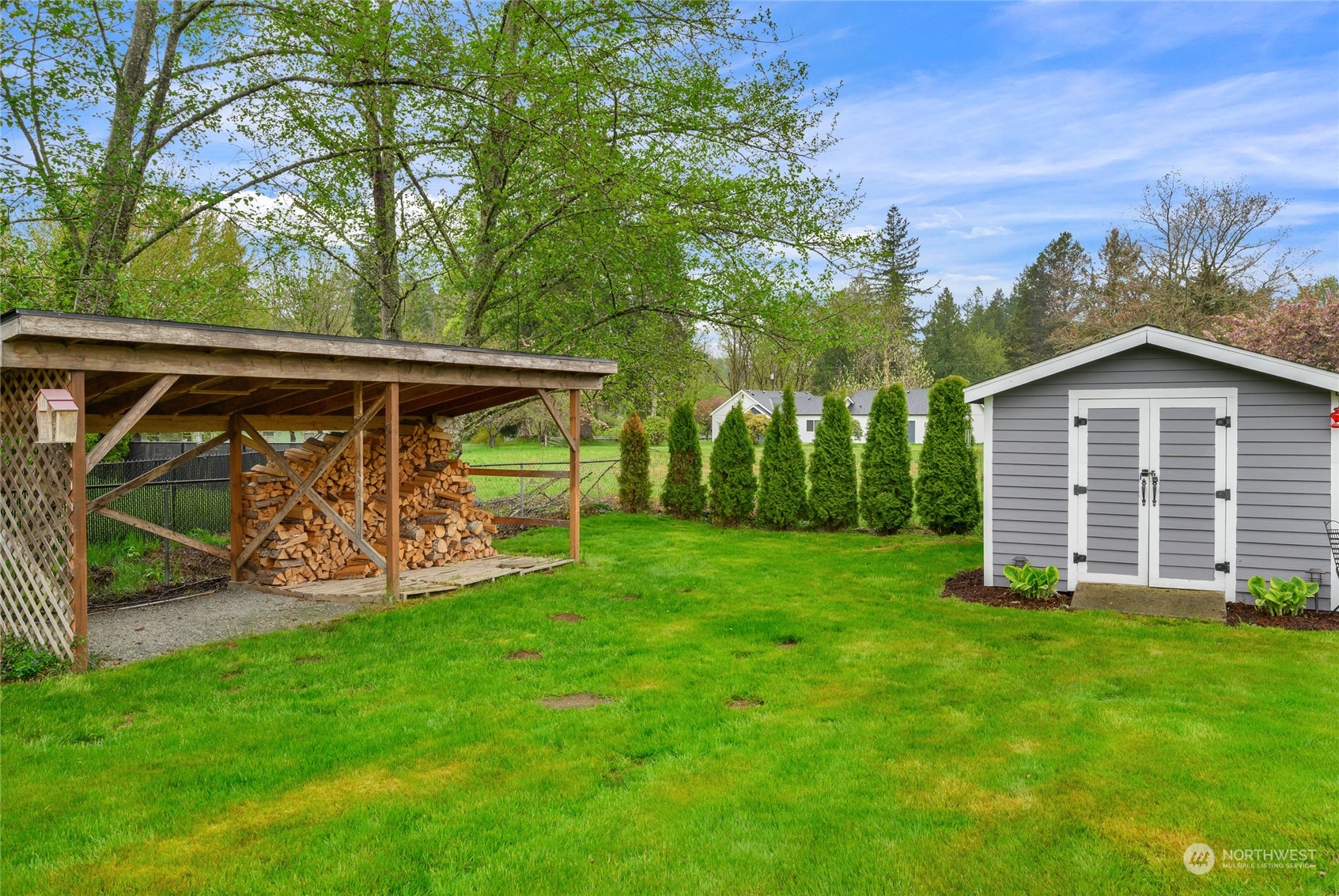 25323 Cromwell Road Monroe, WA 98272 - Photo 29 of 38 a view of a wooden house with a yard