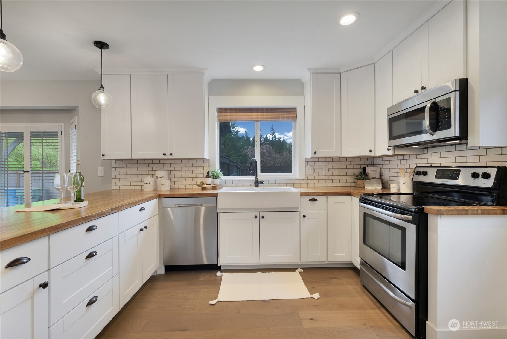 25323 Cromwell Road Monroe, WA 98272 - Photo 9 of 38 a kitchen with white cabinets appliances and a sink