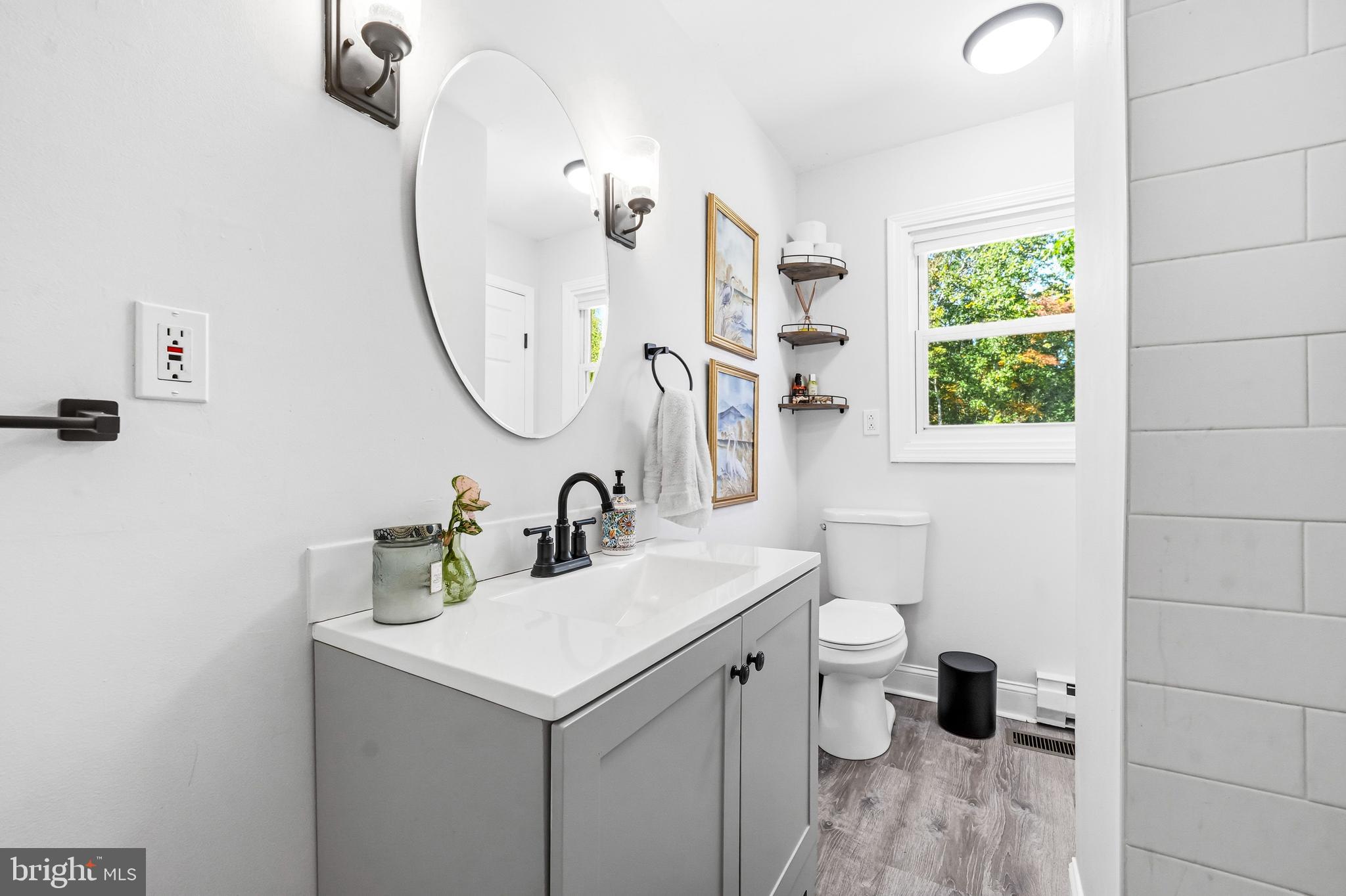 209 Myrtle Lane Berlin, NJ 08009 - Photo 19 of 36 a bathroom with a sink a toilet and a mirror