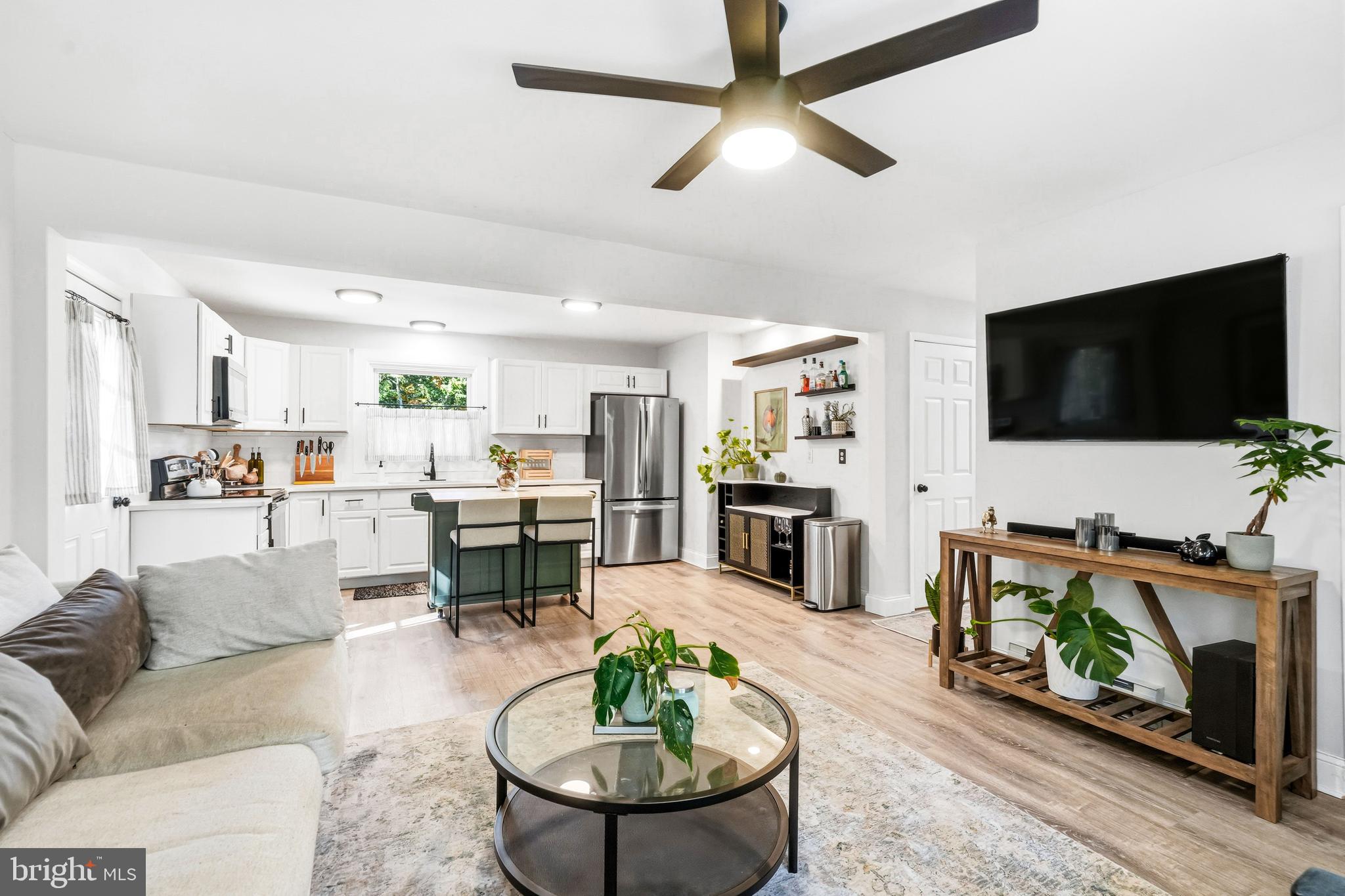 209 Myrtle Lane Berlin, NJ 08009 - Photo 7 of 36 a living room with furniture a flat screen tv and kitchen view