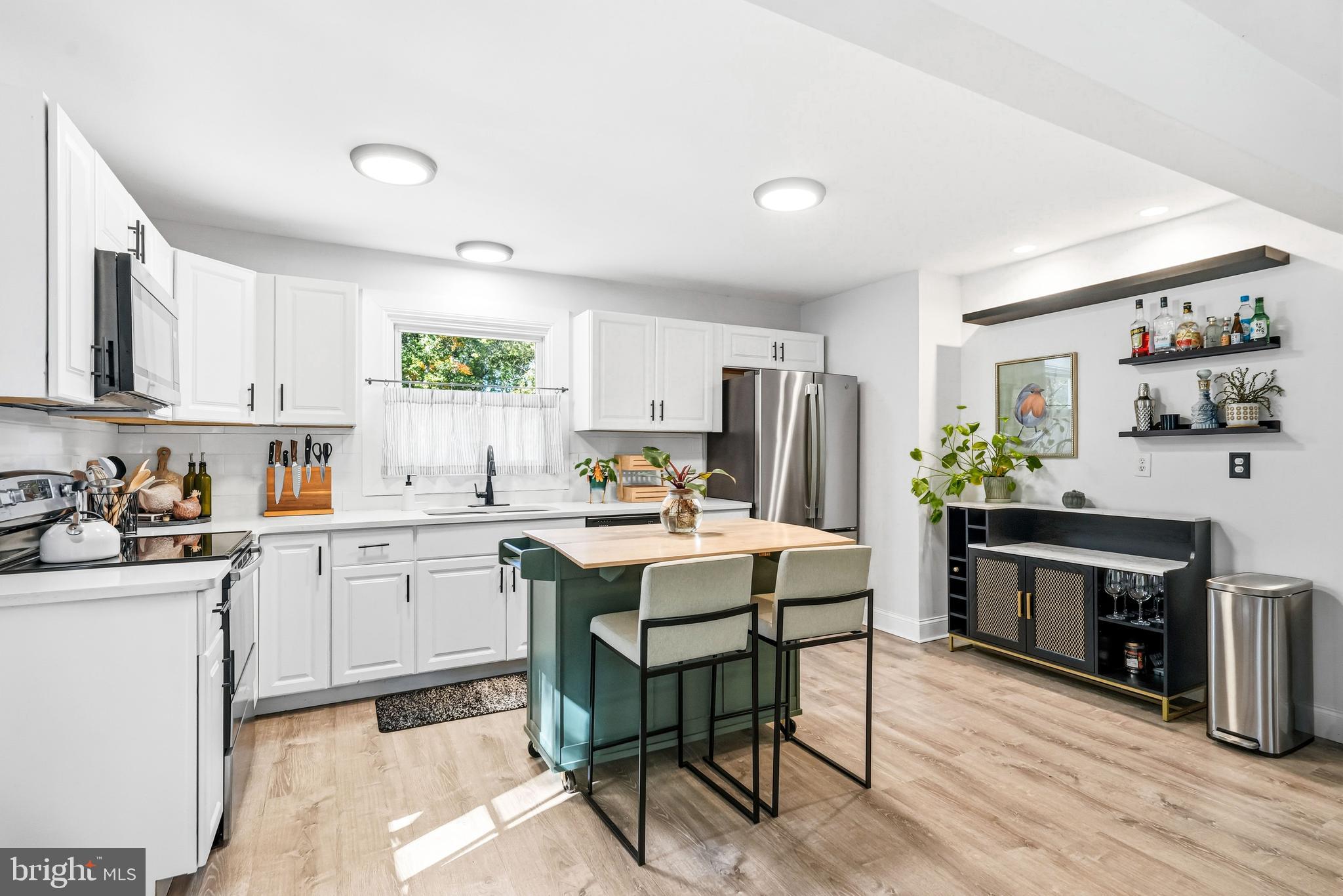209 Myrtle Lane Berlin, NJ 08009 - Photo 8 of 36 a kitchen with a table chairs stove and cabinets